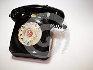 A vintage and antique telephone with white background. photo