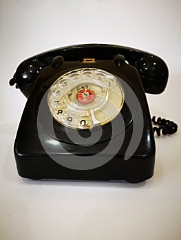 A vintage and antique telephone with white background. photo