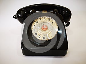 A vintage and antique telephone with white background. photo