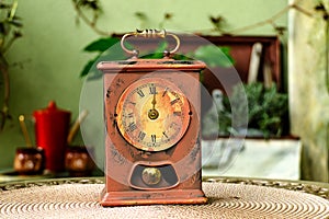 Old vintage clock with pendulum on a table