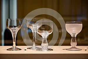 Old and vintage collection of empty wine or champagne bubbles wine glasses on display