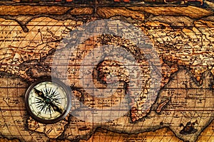 Old vintage compass on ancient map