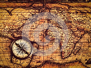 Old vintage compass on ancient map