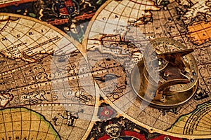 Old vintage compass on ancient map photo