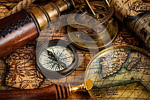 Old vintage compass and travel instruments on ancient map photo