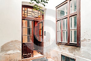 Old vintage courtyard with open entrance door and staircase in Vienna.