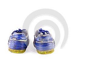 Old vintage damaged futsal sports shoes on white background football sportware object isolated