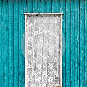 Old vintage door window with white lace curtain