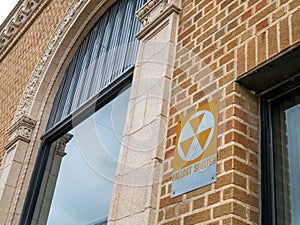 Old vintage fallout shelter sign on a brick exterior wall