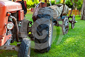 Old vintage farm tractor with cart