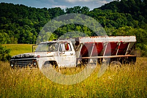 Old vintage farm truck sitting abandon in a pasture field