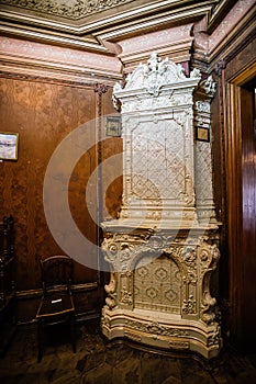 Old vintage fireplace with ceramic Dutch tiles at old mansion