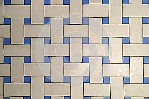 Old vintage floor with geometric mosaic of blue and white tiles