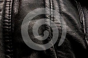 Old vintage genuine soft black leather texture background, top layer with pores and scratches, macro, close-up