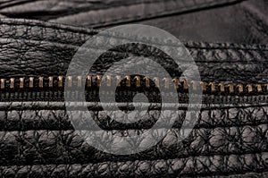 Old vintage genuine soft black leather texture background, top layer with pores and scratches, macro, close-up