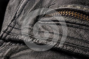 Old vintage genuine soft black leather texture background, top layer with pores and scratches, macro, close-up