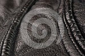 Old vintage genuine soft black leather texture background, top layer with pores and scratches, macro, close-up