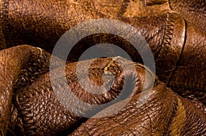 Old vintage genuine soft brown leather texture background, top layer with pores and scratches, macro, close-up