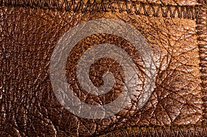 Old vintage genuine soft brown leather texture background, top layer with pores and scratches, macro, close-up