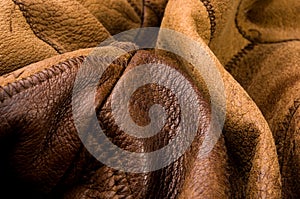 Old vintage genuine soft brown leather texture background, top layer with pores and scratches, macro, close-up