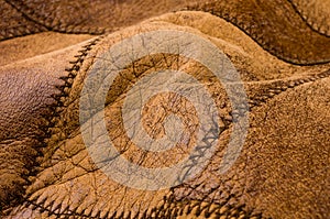 Old vintage genuine soft brown leather texture background, top layer with pores and scratches, macro, close-up