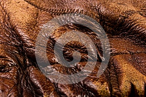 Old vintage genuine soft brown leather texture background, top layer with pores and scratches, macro, close-up