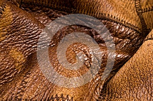 Old vintage genuine soft brown leather texture background, top layer with pores and scratches, macro, close-up