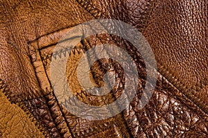 Old vintage genuine soft brown leather texture background, top layer with pores and scratches, macro, close-up