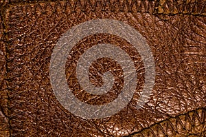 Old vintage genuine soft brown leather texture background, top layer with pores and scratches, macro, close-up