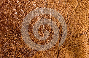 Old vintage genuine soft brown leather texture background, top layer with pores and scratches, macro, close-up