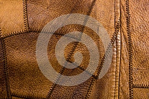 Old vintage genuine soft brown leather texture background, top layer with pores and scratches, macro, close-up