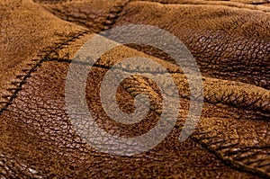 Old vintage genuine soft brown leather texture background, top layer with pores and scratches, macro, close-up