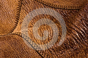 Old vintage genuine soft brown leather texture background, top layer with pores and scratches, macro, close-up