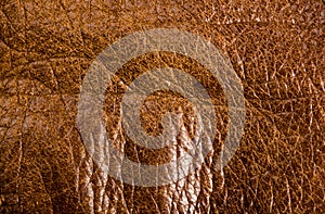 Old vintage genuine soft brown leather texture background, top layer with pores and scratches, macro, close-up