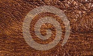 Old vintage genuine soft brown leather texture background, top layer with pores and scratches, macro, close-up