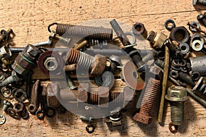 old vintage hand tools - set of screws and nuts on a wooden background