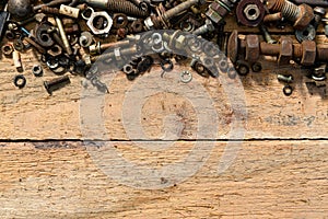 old vintage hand tools - set of screws and nuts on a wooden background with blank space for text