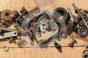 old vintage hand tools - set of screws and nuts on a wooden background