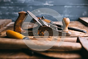 Old vintage hand tools on wooden background. Carpenter workplace.