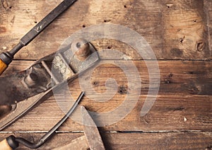 Old vintage hand tools on wooden background.