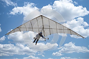 Old vintage hang glider paraglider kite in the sky with clouds