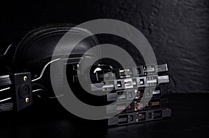 Old Vintage Headphone with Cassette Tapes in Dark Background