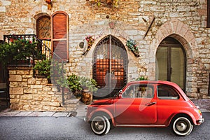 Old vintage italian scene. Small antique red car. Fiat 500