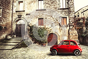 Old vintage italian scene. Small antique red car. Fiat 500