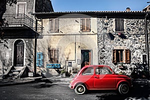 Old vintage italian scene. Small antique red car. Fiat 500
