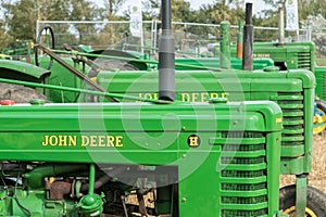 Old vintage john deere tractors in a row