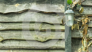 Old vintage lamp on wooden fence