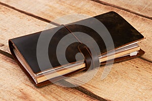 Old vintage leather book on wooden background