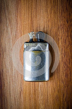 Old vintage lighter on a wooden background