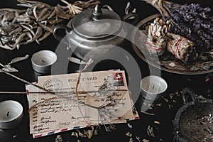 Old vintage looking bundle of postcards hand written in cursive on a dark black messy table